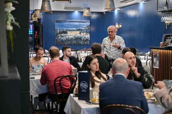 Theo Poulakidas delivers dishes at his restaurant Theio Theo.