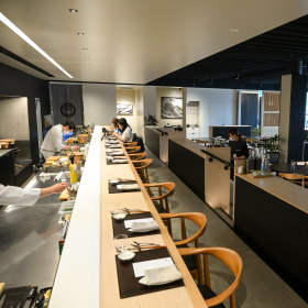 The hottest seats are at the wooden omakase bar.