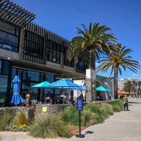 Outdoor tables are just metres from the  beach.