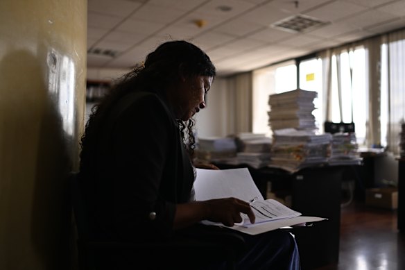 Environmental lawyer Yuly Tenorio inspects documents in Ecuador’s capital, Quito, relating to court cases over illegal mining in La Merced de Buenos Aires.