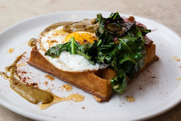 Sourdough waffle with curry sauce, hot honey and sour greens.