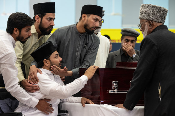 Muzafar Ahmed Tahir (bottom left), brother of Faraz Tahir, at his funeral on Friday.