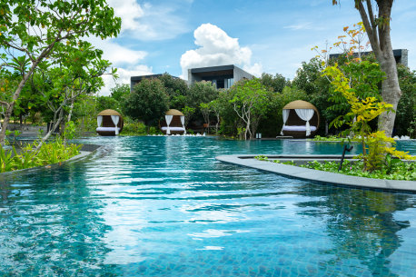 Hotel pool and villas surrounding it.