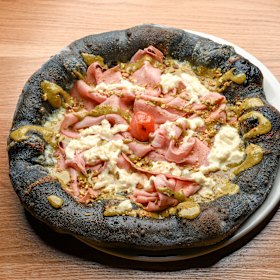Mortadella pizza on a charcoal dough base.