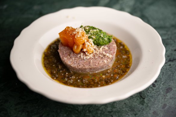 Cotechino, a puck of gutsy, rubbly pork sausage, with lentils.
