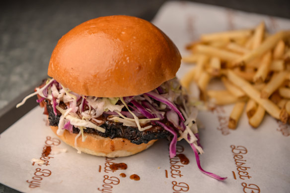 A bun with beef brisket and fries. 