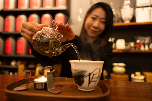 Founder of Ms. Cattea Cathy Zhang prepares Nine Mountains green tea on a candle burner. 