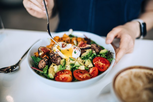 Close up of woman eating healthy meal, anti-inflammatory diet
