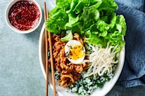 Korean beef and green rice bowl with soft-boiled eggs.