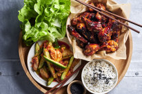 Sticky Korean chicken wings with kimchi-pickled cucumbers.