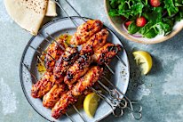 Kanat chicken wings with sumac, tomato and onion salad.