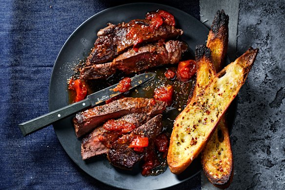 This easy steak dish is packed with flavour thanks to roasting tomatoes with anchovies and garlic.