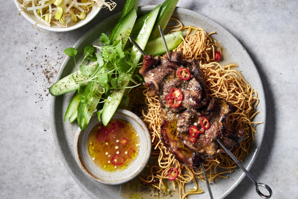 Vietnamese beef skewers with crispy noodles.