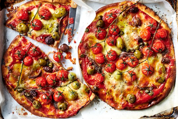 Lebanese bread stands in for dough so you can make these summer puttanesca pizzas in 20 minutes.