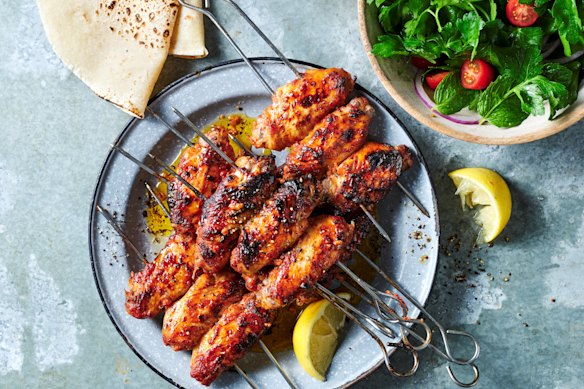 Kanat chicken wings with sumac, tomato and onion salad.