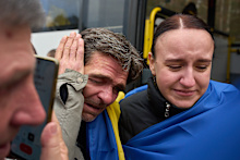 Residents of Oleshky react after being evacuated from their Russian-occupied hometown.