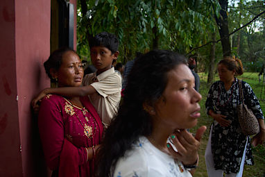 People wait for news of their relatives who are missing after flash flooding along the Trishuli River in Nepal’s Nuwakot district.