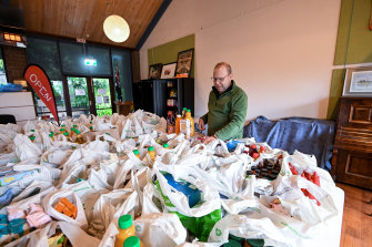 Reverend Andrew Smith with donated goods he will distribute to people in Kalorama. 