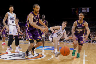Kings captain Xavier Cooks and Adelaide’s Nick Marshall run for a loose ball at Qudos Bank Arena.