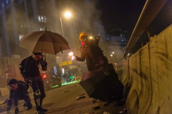 Protesters confront police near the Polytechnic University siege in the Tsim Sha Tsui district.