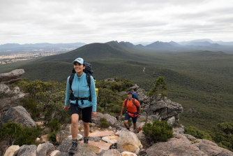 Hikers walk up the lower slopes of Signal Peak on the Grampians Peaks Trail