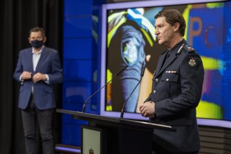 Chief Commissioner Shane Patton, flanked by Premier Daniel Andrews, speaks to media this morning.