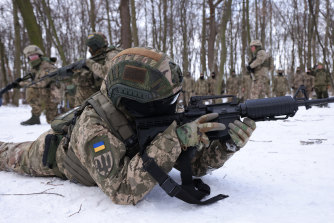 Civilian participants in a Kyiv Territorial Defence unit train in a forest near Kyiv.