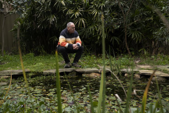 Mark Avery by one of the po<em></em>nds in his backyard, which provide a habitat for frogs.