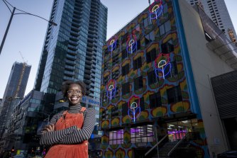 Atong Atem outside Hanover House, which has been transformed by her work  âOutdoor Livingâ, 2021.   