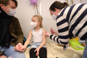 A child receives the Pfizer vaccine in Germany. Australian children aged five to 11 can be vaccinated from this week.