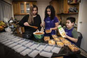 Sherin Fishwick and her children Ameera, 13, and Gabriel, 7, cooking pasta for the less fortunate.