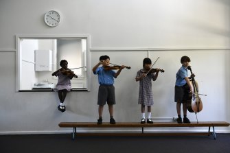 Year 3 and 4 students at St Joseph The Worker primary school in Auburn with their instruments.