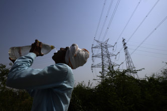 A labourer quenches his thirst working outside on a 45-degree day in Delhi.