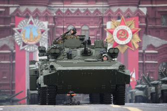 Russian military vehicles roll across the red Square ahead of Vladimir Putin's speech. 