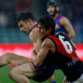 Jye Caldwell lays a tackle on Josh Dunkley in the elimination final at Launceston.