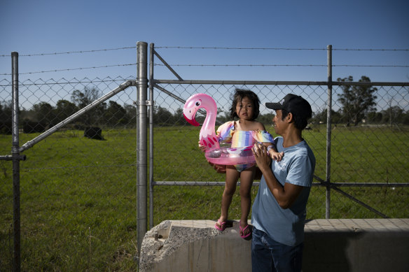 Daniyah Duran is among those missing out on swimming classes because there are not enough pools. She is pictured with her father Ronald where there would be an aquatic centre if Blacktown Council could afford to build it.