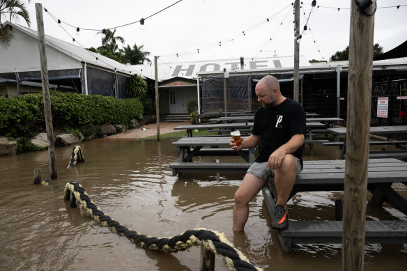 Brett Strauss outside his flooded pub  the Harwood Hotel.