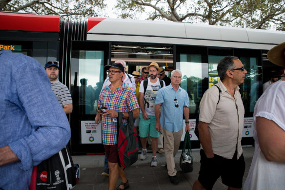 Crickets fans arrive at the SCG by tram.