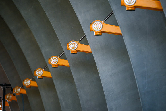 The “MM” symbol for “Melbourne Metro” is used throughout the stations including on these “cockatoo” light fittings at Arden station. 