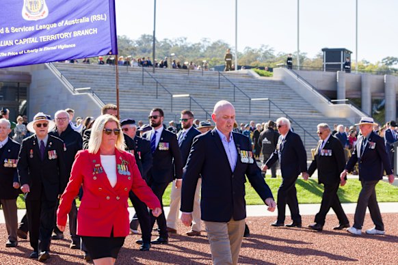 Luke McCallum (right) marching with RSL CEO Kimberley. Hicks 