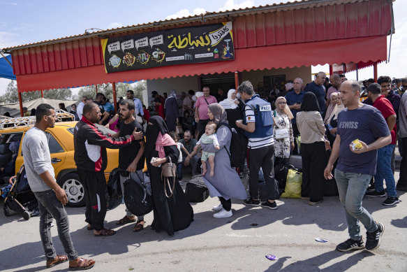 Palestinians wait to cross into Egypt at the Rafah border crossing in the Gaza Strip on October 16. 