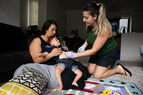 Veronica Carbone from Heartfelt Support Services helps Jennifer Brankin with the feeding of her 7-year-old son, Alexander, who has Joubert Syndrome.