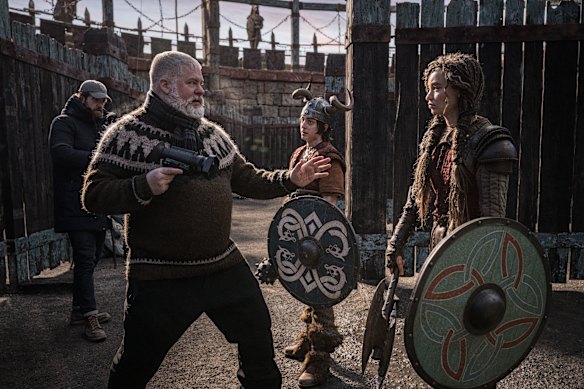 Writer-director Dean DeBlois offers some dragon-fighting tips to Nico Parker on the Belfast set of the movie. 