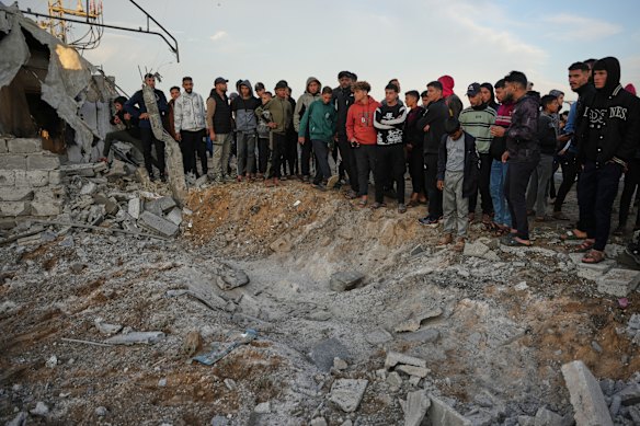Palestinians inspect the damage caused by an Israeli airstrike in Deir al-Balah, central Gaza Strip.