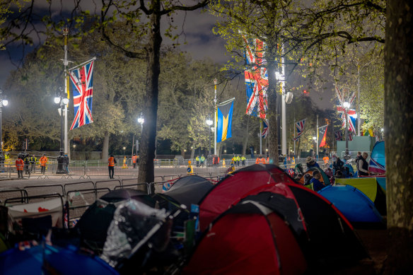 Royalists camp alongside the planned route of King Charles III near Buckingham Palace.