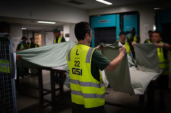 So-called “trusted” inmates fold washing for a small allowance each week.