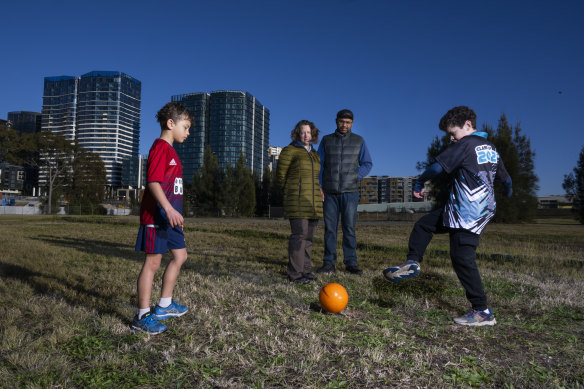 Amy and Francisco de Paula with sons Felix and Toby on the government-owned site at Wentworth Point that is slated for development.