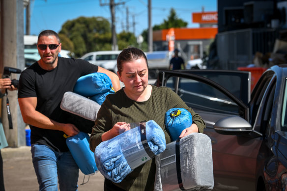 Sevnur Karaman, front, brings donations to the container behind Sultan Butcher in  Campbellfield on Tuesday, with some help from volunteer Konur Alp Ozal.