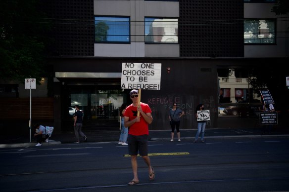 Refugee advocates outside Park Hotel in Melbourne after Novak Djokovic was driven into the underground car park of the Carlton building by officers on Saturday afternoon.