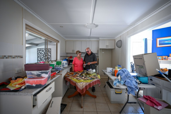 Hazel and West Brierley look over family photos ruined in Rochester’s record flood.